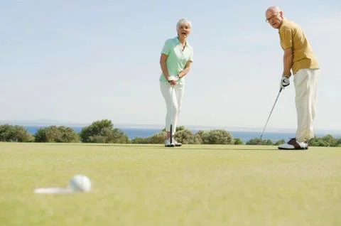 Spain, Mallorca, Senior couple playing golf Stock Photos