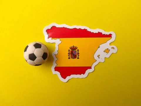 A Spain map sticker printed with its national flag design sits next to a mi.. 库存照片