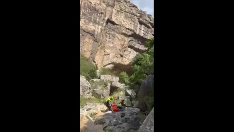Spain: Mountain Rescue Helicopter Winch Evacuates Injured Woman From Span... Stock Footage 336223609