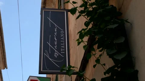 Spain, Soller, 08-28-2025. Facade Italian restaurant. Made in Italy. Panning 4K Stock Footage 316760876