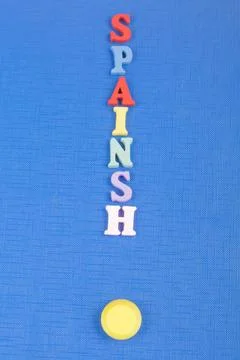 SPAIN word on blue background composed from colorful abc alphabet block woode Stock Photos