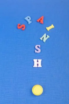 SPAIN word on blue background composed from colorful abc alphabet block woo.. Stock Photos
