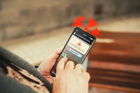 Spam text message on smartphone screen. Stock Photos