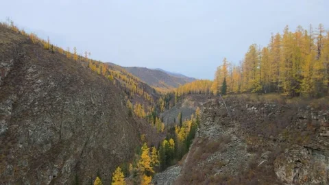 Span along the cliff of a rocky gorge, two people stand on the edge Video stock 147241815