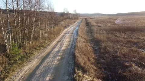 Span along a rural dirt road in early spring Stock Footage