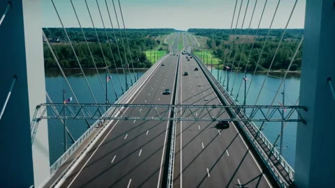 A span between cable-stayed structures above the truss for traffic signs and Stock Footage 257784080