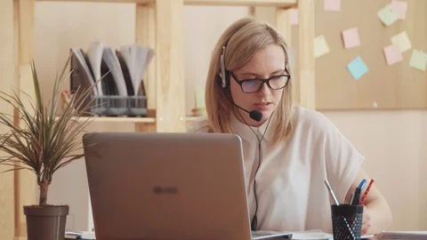 The span of the camera shows a busy work life in the office, she has time to Stock Footage 106126307