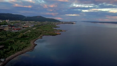 The span of the drone along the coast with a typical Soviet city. Beautiful Stock Footage 104575819