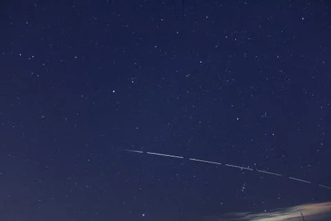The span of the ISS against the background of the constellation Orion Stock Photos