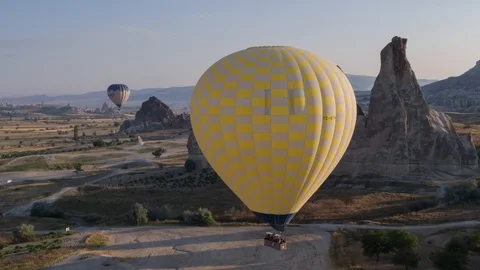 The span of a large yellow balloon, in a basket of people, close-up. Cappadocia Stock Footage 105508619