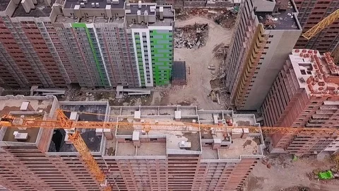 Span over the roofs of a building of a high-rise building of brick with cranes Stock Footage 126701071