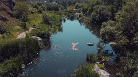 Span over the wild small river with rapids and stones Stock Footage 127630727
