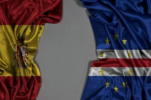 Spanish And Cape Verde Flags Side by Side On Satin Fabric For International Rela Stock Photos