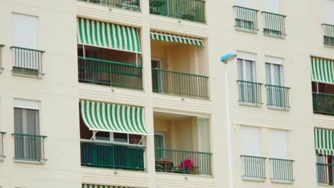 Spanish apartment building with security bars and roller shutters. Residential Stock Footage 341952570