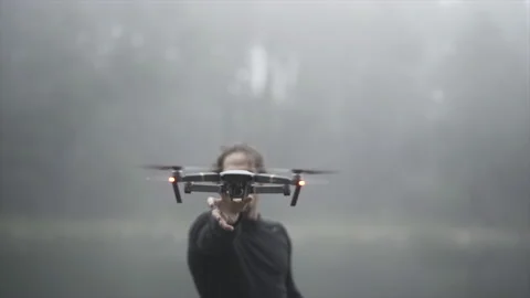 Spanish boy flies a drone in front of a lake in Andorra Video stock 221512869