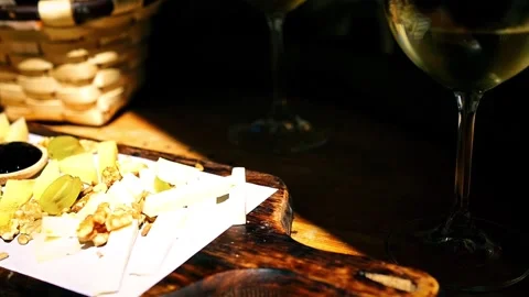 Spanish cheese platter served in a tapas bar with Galician white wine Albariño Stock Footage 282660957