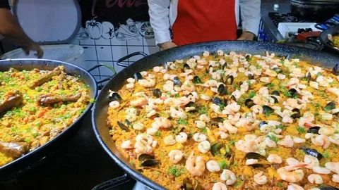 Spanish dish called Paella meat seafood vegetables and rice Stock Footage