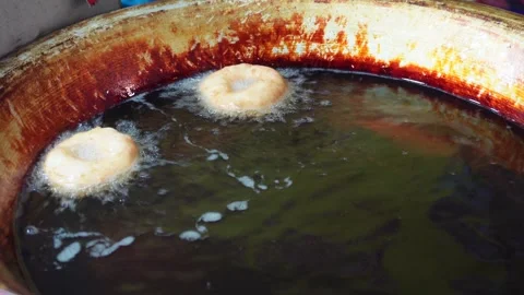 Spanish doughnut, being deep fried Stock-Footage 326328273