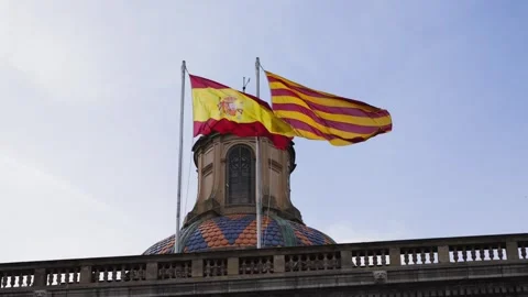 The Spanish flag and the Catalan flag are flying on the administrative building. Stock Footage 314379719