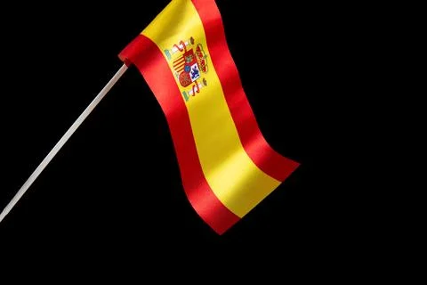 The Spanish flag on a black background developing and fluttering in the wind Fotos Stock