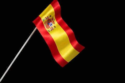 The Spanish flag on a black background developing and fluttering in the wind Photos