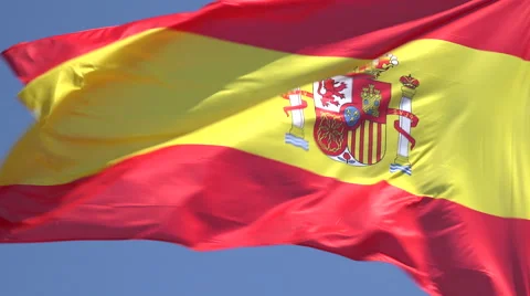 Spanish flag blowing in wind with blue sky background, Spain Stock Footage 49952324