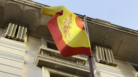 Spanish flag flying above window of building Stock Footage 255288671