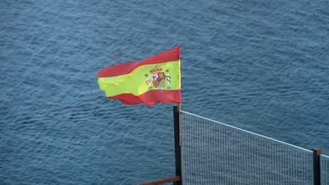 Spanish flag with sea at the background. 4x slow motion Stock Footage 80060869