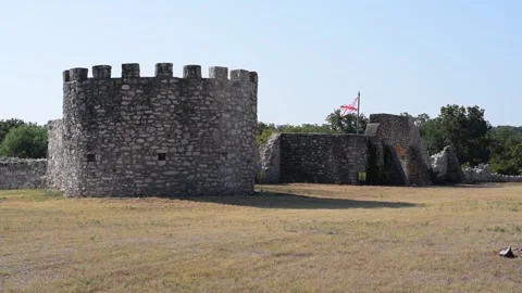 Spanish flag waving over old texas fort ruins Stock Footage 138117583