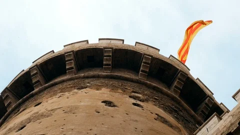 Spanish flag waving on the Torres de Quart, gateway to the medieval Christian Stock Footage 102155169