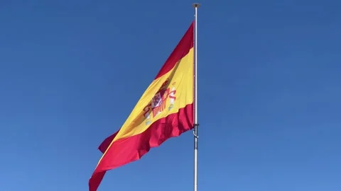 Spanish flag waving vibrantly on flagpole capturing national pride with red Stock Footage 341383047