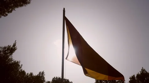 Spanish Flag in Wind Through Sun Light Stock Footage 99351937