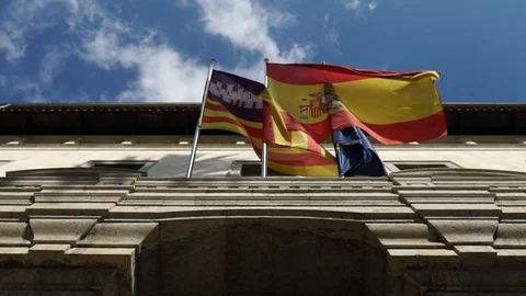 Spanish flags outside an embassy in slow motion Stock Footage 100445510