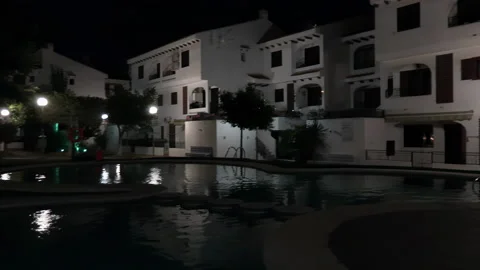 Spanish Garden Swimming Pool Panning to Water at Night 動画素材 196893353