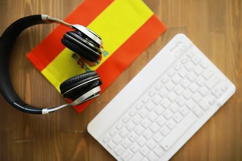 Spanish Language Learning Concept with Headphones, Keyboard, and Spanish Flag Stock Photos