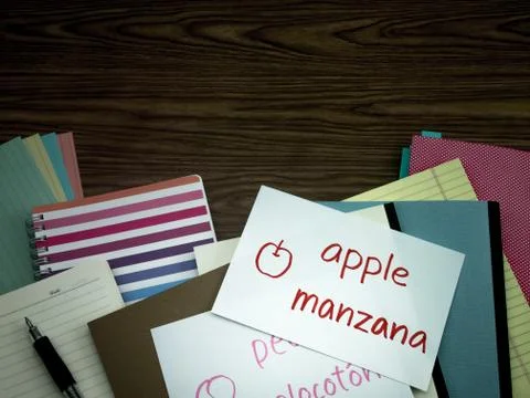 Spanish; Learning New Language Writing Words on the Notebook Stock Photos