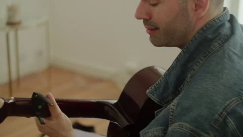 Spanish Man Playing Classical Guitar And Singing At Home Stock Footage 336687198