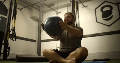 Spanish man practicing pilates with a ball in the gym Stock Footage 169187280