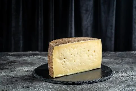 Spanish manchego aged cheeses on rustic wooden table. banner, menu, recipe .. Stock Photos