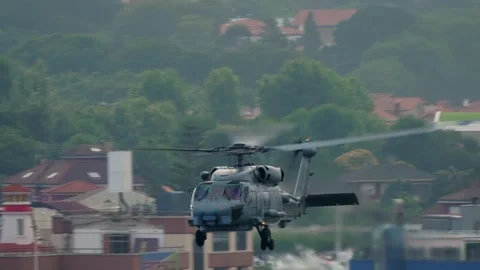 Spanish Navy SH-60 Seahawk head on approach over Gijon urban rooftop Stock Footage 336279100