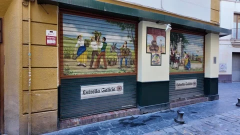 Spanish painting displayed on a roll-down metal shutter in Seville Stock Footage 296708596