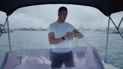 Spanish ship skipper looks at his watch ... | Stock Video | Pond5