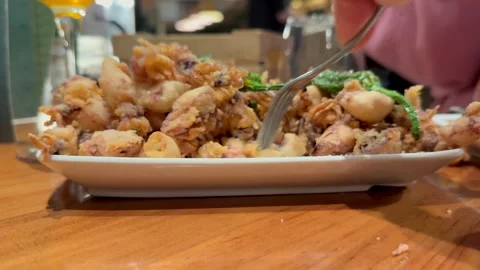 Spanish Tapas: Couple Sharing Fried Calamari in a Traditional Bar. Stock Footage 335181988