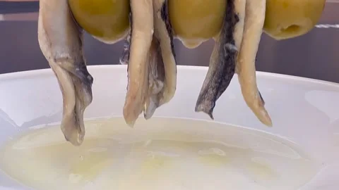 Spanish Tapas: Extreme Closeup View of a Skewer with Anchoives and Green Olives Stock Footage 335449799