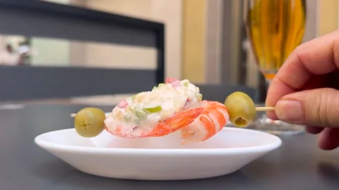 Spanish Tapas: Hand of a Caucasian Man Taking Shrimp Skewer form a Plate in a Stock Footage 337012471