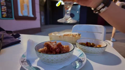 Spanish Tapas: Hand of a Man Eating Torreznos and Drinking Beer in a Terrace at Stock Footage 337872229