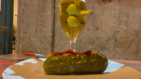 Spanish Tapas: Hand of a Man Enjoying Skewer of Pickle Filled with Tuna Fish Stock Footage 333550749