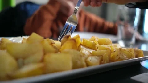 Spanish tapas seafood fish potatoes tortilla hands children family eating Stock Footage 235608461