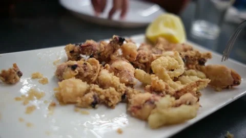 Spanish tapas seafood fish potatoes tortilla hands children family eating Stock Footage 235608464