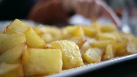 Spanish tapas seafood fish potatoes tortilla hands children family eating Stock Footage 235608481